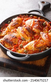 Baked Chicken With Sofrito Vegetable Sauce Close-up In A Frying Pan On The Table. Vertical
