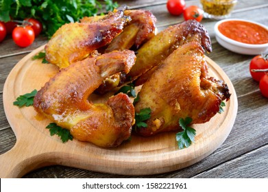 Baked Chicken Teriyaki Wings In Honey Mustard Sauce On Wooden Background.  Asian Recipe.