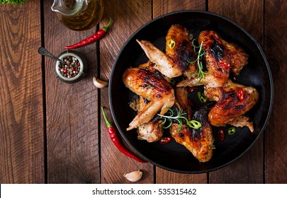 Baked Chicken Wings In Pan On Wooden Table. Top View