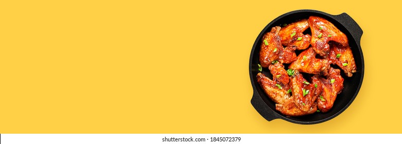 Baked Chicken Wings With Sauce. Yellow Background. Top View