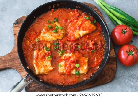 Baked cod fish in tomato and pepper sauce