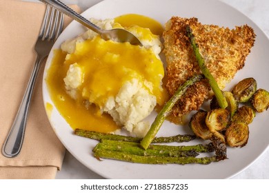 baked cod  and nashed potatoes  served with  roasted vegetables