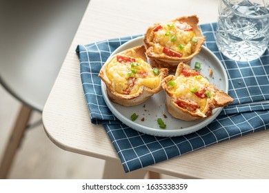 Baked egg, ham, tomato and toast cup for breakfast brunch.