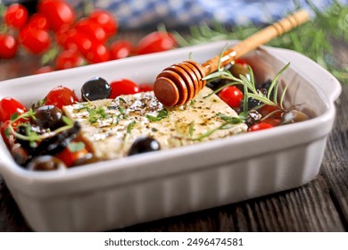 Baked feta cheese with cherry tomatoes, olives, garlic, honey and herbs 
 - Powered by Shutterstock