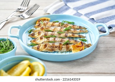 Baked Fish With Rosemary And Lemon On A Blue Plate, Selective Focus.