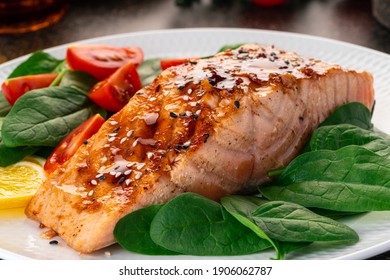 Baked or fried salmon and salad, Paleo, keto, fodmap, dash diet. Mediterranean food with steamed fish. Oven asian dish with teriyaki. Healthy concept, gluten free, lectine free, side view