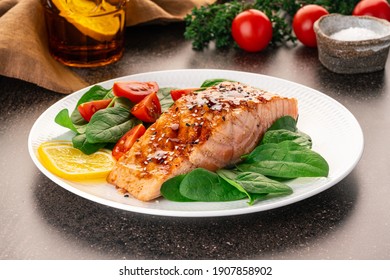 Baked or fried salmon and salad, Paleo, keto, fodmap, dash diet. Mediterranean food with steamed fish. Oven asian dish with teriyaki. Healthy concept, gluten free, lectine free, side view