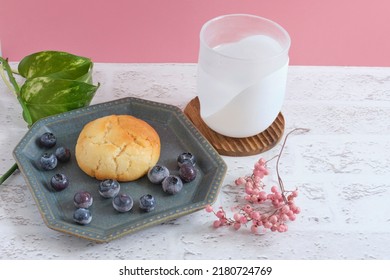 Baked Goods And Frozen Blueberries Served On A Ceramic Plate	