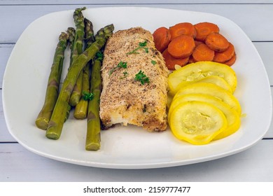 baked haddock served with asparagus carrots and summer squash,