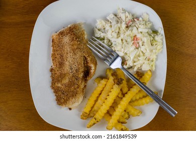 Baked Haddock Served With Cole Slaw And Fries