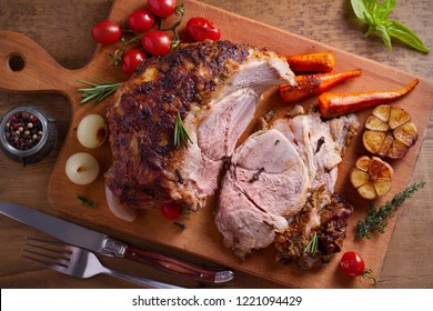 Baked Ham With Vegetables, Rosemary And Thyme On Chopping Board. Overhead, Horizontal