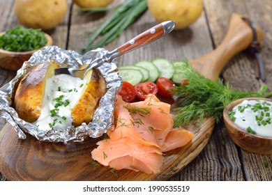 Baked Jacket Potato Fresh From The Oven Served With Chives Sour Cream And Smoked Salmon 