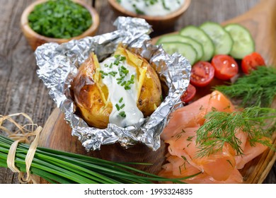 Baked Jacket Potato Fresh From The Oven Served With Chives Sour Cream And Smoked Salmon 