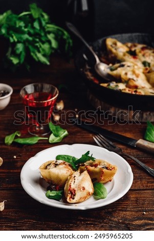 Baked jumbo shells pasta stuffed with ground beef, spinach and cheese on white plate