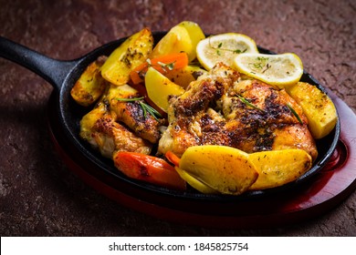 Baked Lemon Chicken With Potatoes, Carrots And Herbs Served In Pan.