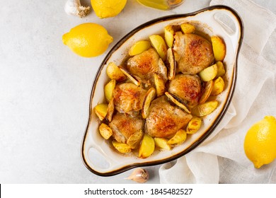 Baked Lemon Garlic Chicken And Butter With Potato. Light Grey Background. Top View.