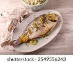 Baked lemon and thyme whole sea bream fish