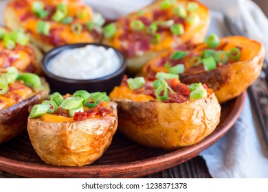 Baked Loaded Potato Skins With Cheddar Cheese And Bacon, Garnished With Scallions And Sour Cream, Horizontal