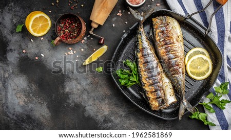 baked mackerel fish in a pan with lemon herbs and spices, banner, menu recipe place for text, top view,