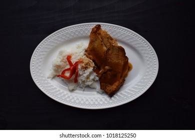 baked meats and rice on a withe plate