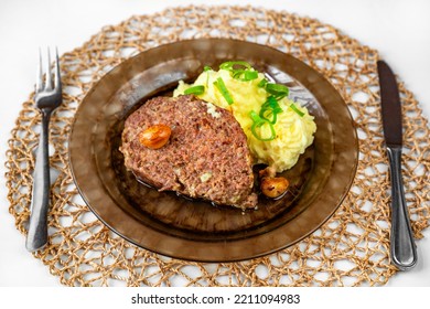 Baked Minced Beef, Garlic And Mashed Potato On Plate, Cutlery And Bamboo Pad On Table. Serving Size, Lunch Or Dinner.