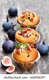 Baked  muffins with figs on rustic wooden table 