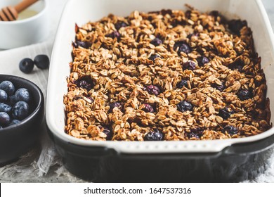 Baked Oatmeal With Blueberries And Honey In The Oven Dish. Oatmeal Fruit Crumble Pie.