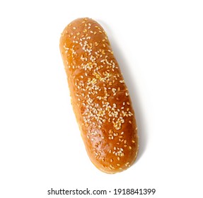 Baked Oval Hot Dog Bun, Baked Goods Sprinkled With Sesame Seeds And Isolated On White Background, Top View