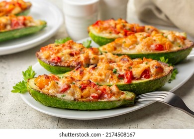 Baked in oven Zucchini stuffed with chicken meat, belle peppers, tomatoes and cheese. Close-up. - Powered by Shutterstock