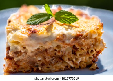 Baked pasta casserole pastitsio with rich bechamel sauce and ground beef. Preparing traditional greek food recipe. - Shutterstock ID 1818778319