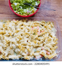 Baked pasta and cheese in glass tupperware - salad portion beside it - Homemade - Shutterstock ID 2280405491