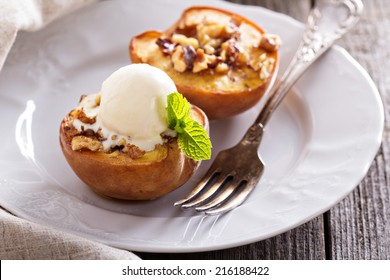 Baked peaches with ice cream on a plate