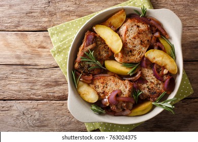 Baked Pork Fillet With Green Apples, Onions And Rosemary Close-up In A Dish. Horizontal Top View From Above
