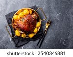 Baked pork knuckle with potatoes and cheese sauce on grey background top view. High quality photo