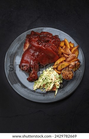 Baked pork knuckle with vegetables. Cabbage salad. Homemade grilled potatoes. Traditional beer snack. Vertical photo. Top view. Copy space.