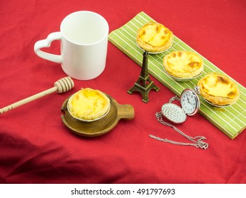 Baked Portuguese Egg Tarts on red background - Shutterstock ID 491797693