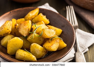 Baked potato with rosemary on plate rustic style
