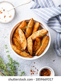 Baked Potato Wedges With Paprika, Thyme And Sauce On A Light Background, Top View