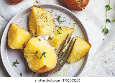 Baked potatoes with butter and thyme.