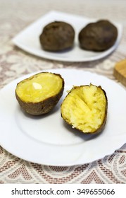 Baked potatoes cut into halves on the table
