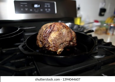 Baked Prime Rib Roast Resting On The Stove Top In A Cast Iron Skillet. 