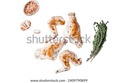 Baked rabbit legs on a grill with thyme. Isolated on white background, top view