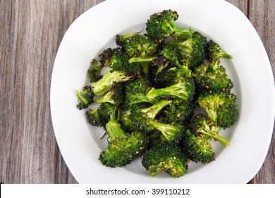 Baked Roasted Garlic Parmesan And Olive Oil Broccoli Side Dish On Wooden Table