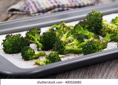 Baked Roasted Garlic Parmesan And Olive Oil Broccoli Side Dish On Wooden Table