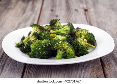 Baked Roasted Garlic Parmesan And Olive Oil Broccoli Side Dish On Wooden Table