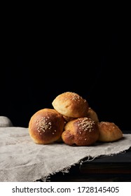 baked round bun with sesame seeds, black background, home baking, copy space - Shutterstock ID 1728145405
