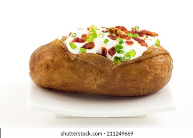 Baked Russet Potato With All The Trimmings On White Background