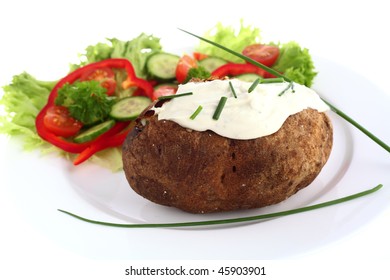 A Baked Russet Potato, Topped With Cream Cheese And Chives And Served With A Salad