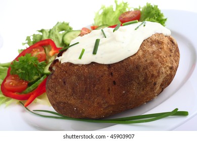 A Baked Russet Potato Topped With A Cream Cheese, Herbs And Chives Mixture, Served With A Garden Salad.