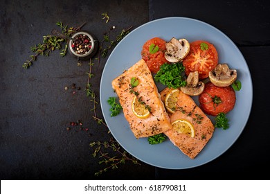 Baked salmon fish fillet with tomatoes, mushrooms and spices. Diet menu. Top view. Flat lay